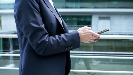 Cropped-shot-of-businesswoman-using-smartphone